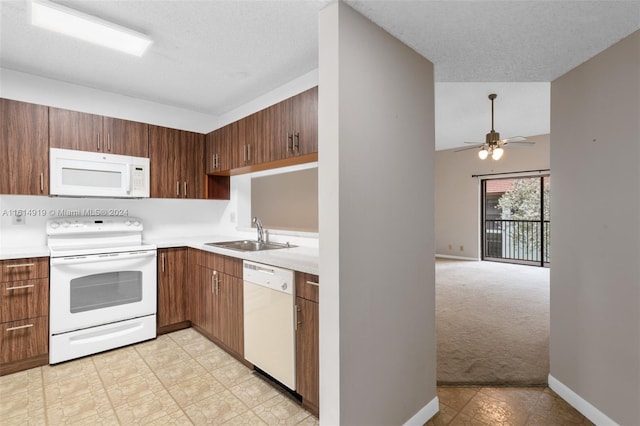 kitchen with white appliances, sink, a textured ceiling, light carpet, and ceiling fan