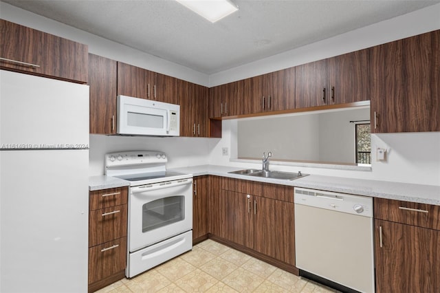 kitchen with white appliances, a textured ceiling, sink, and dark brown cabinetry