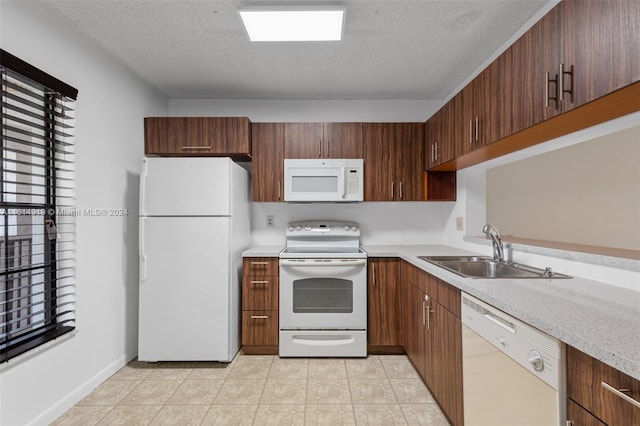 kitchen with white appliances, a textured ceiling, and sink