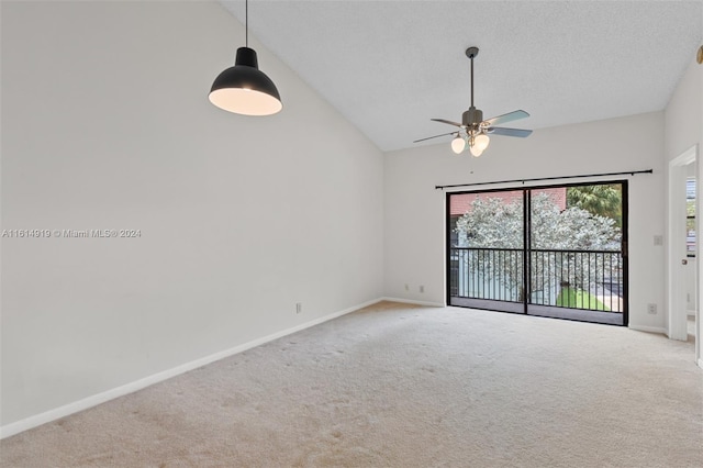 carpeted spare room featuring lofted ceiling, a textured ceiling, and ceiling fan