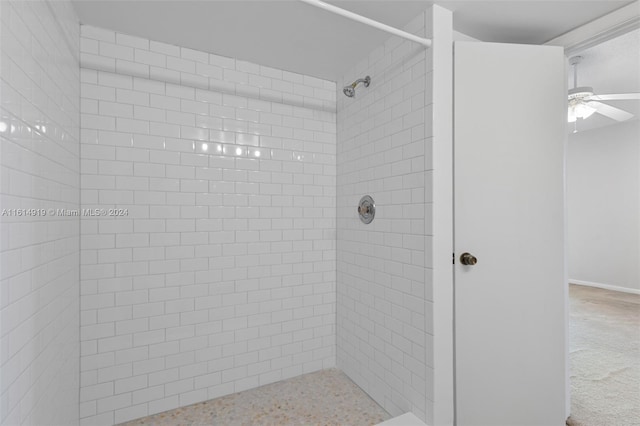 bathroom with tiled shower and ceiling fan