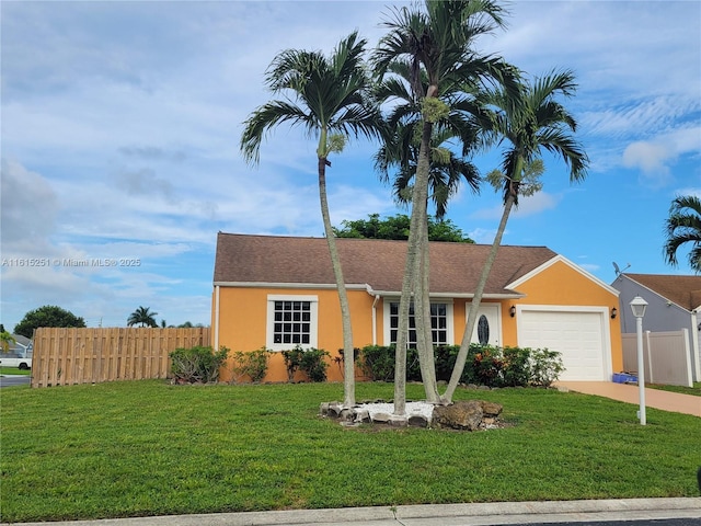 ranch-style home with a front lawn and a garage