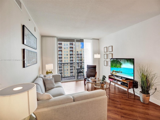 living room with floor to ceiling windows, hardwood / wood-style floors, and a textured ceiling