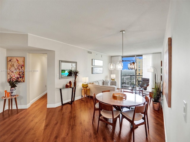 dining space with hardwood / wood-style flooring and expansive windows