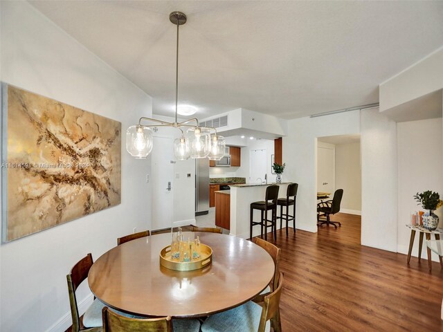 dining area with sink and hardwood / wood-style floors