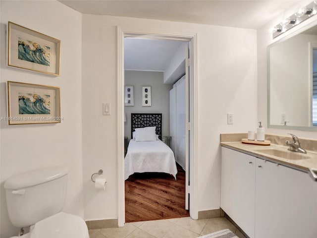 bathroom with tile patterned flooring, vanity, and toilet