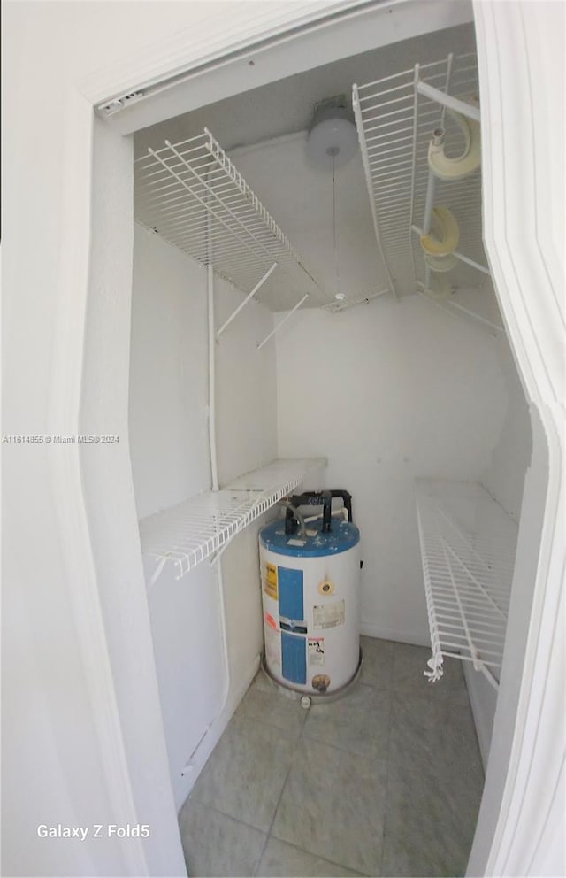 interior space featuring water heater and light tile patterned flooring