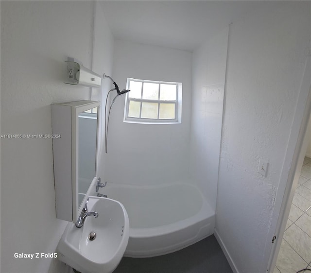 bathroom with shower / bathtub combination, sink, and tile patterned flooring