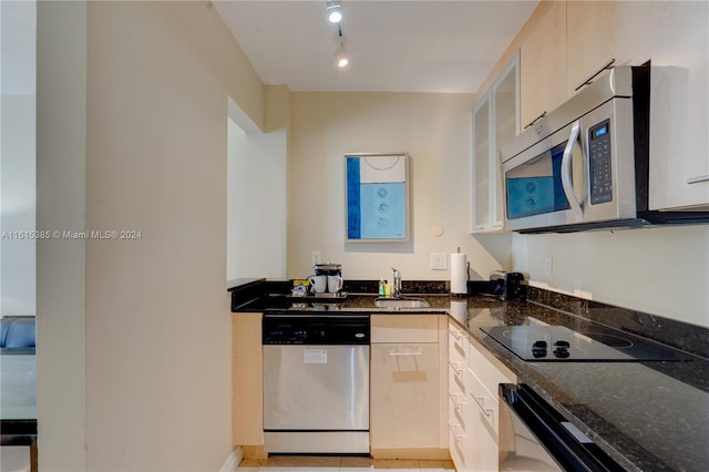 kitchen featuring light tile patterned flooring, rail lighting, stainless steel appliances, light brown cabinetry, and sink