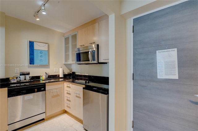 kitchen with stainless steel appliances, light brown cabinets, sink, light tile patterned floors, and track lighting