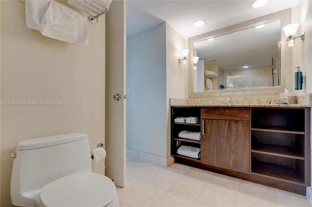 bathroom with tile patterned floors, vanity, and toilet