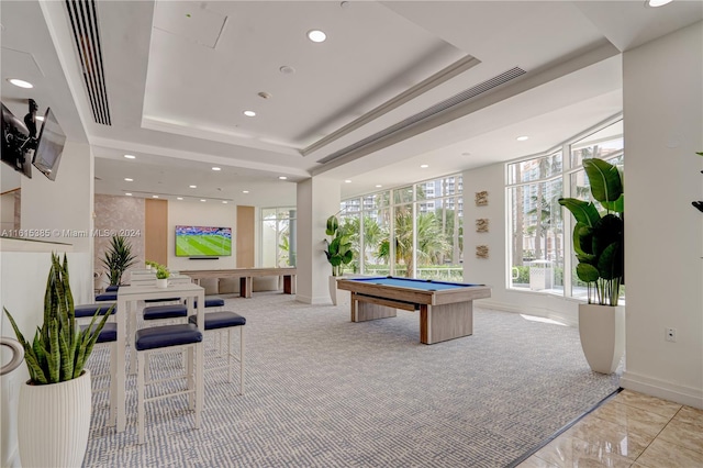 rec room with light carpet, a raised ceiling, and billiards