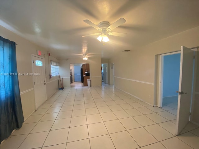 empty room with light tile patterned flooring and ceiling fan