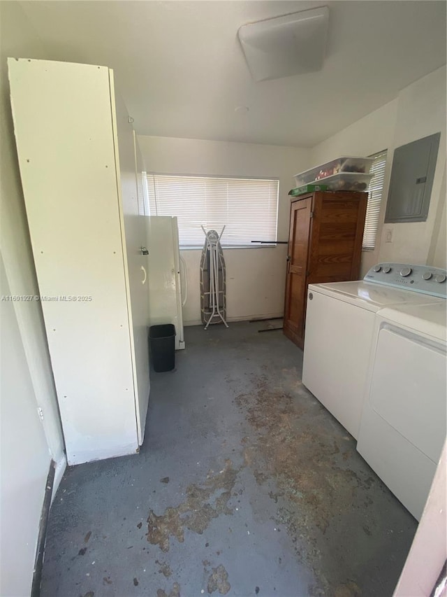 laundry room with electric panel, separate washer and dryer, and laundry area