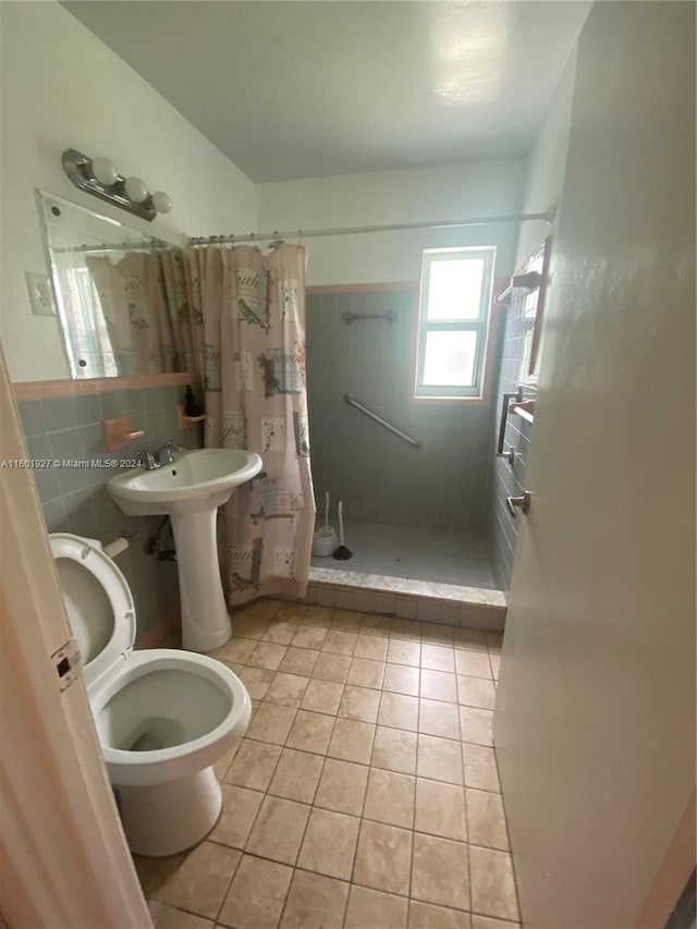 bathroom featuring tile flooring, tile walls, walk in shower, sink, and toilet