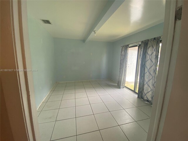 unfurnished room featuring light tile floors