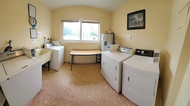 washroom featuring washer and dryer, washer hookup, sink, light tile flooring, and electric water heater