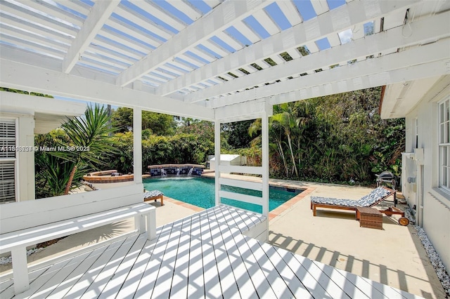 view of pool with pool water feature, a pergola, and a patio area