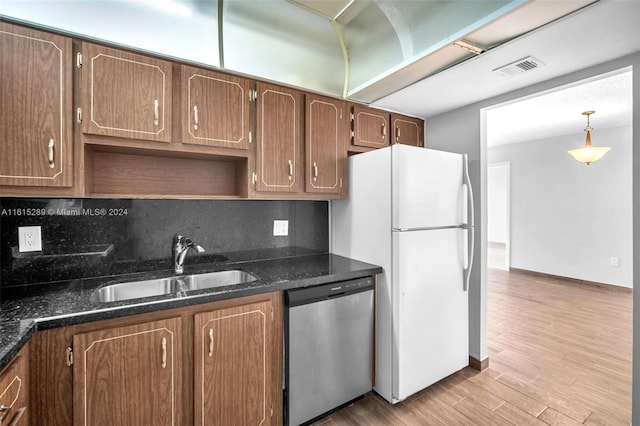 kitchen with decorative backsplash, sink, light hardwood / wood-style flooring, dishwasher, and white fridge