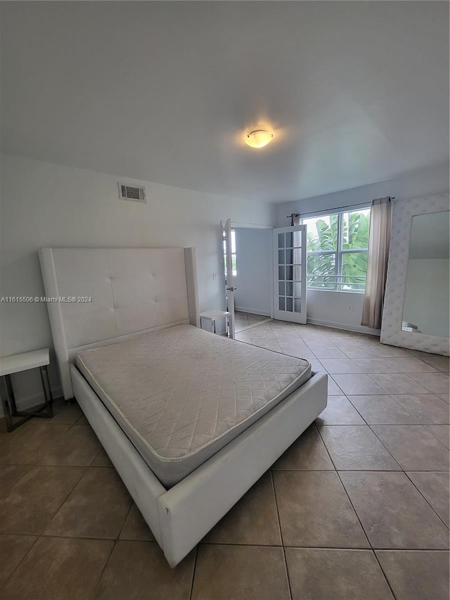 bedroom featuring tile floors