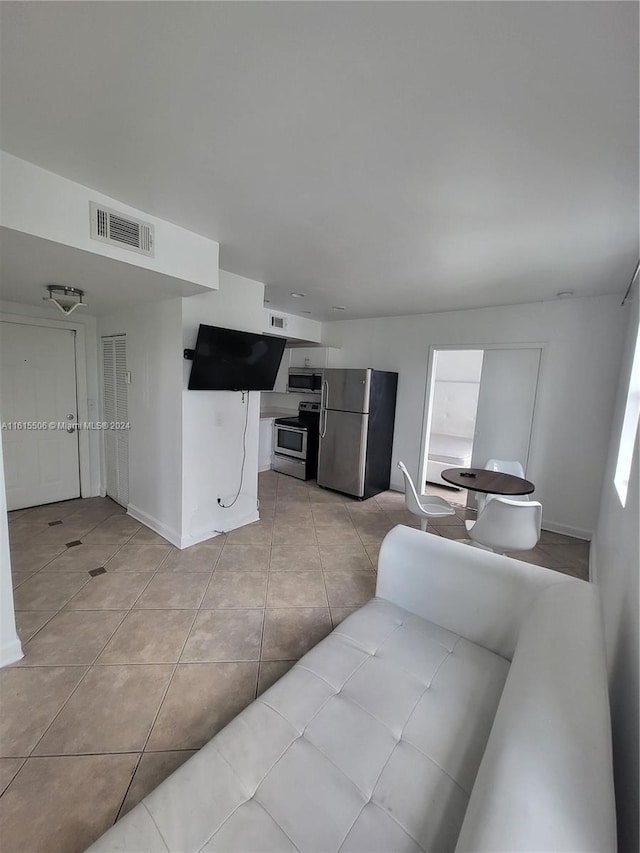 kitchen featuring appliances with stainless steel finishes and light tile flooring