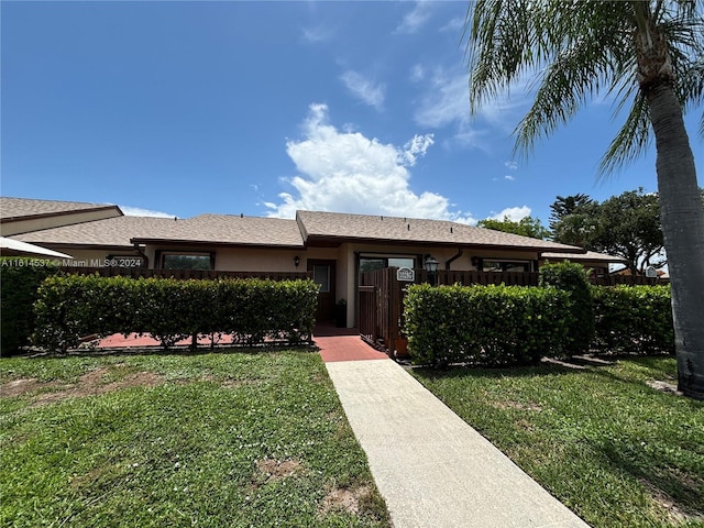 ranch-style home with a front lawn