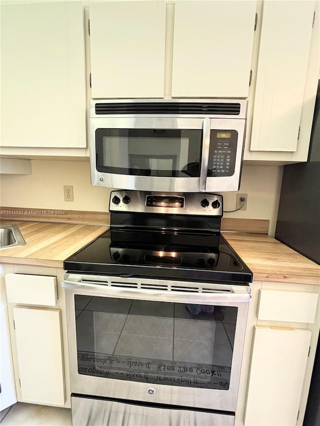 kitchen with white cabinets and appliances with stainless steel finishes