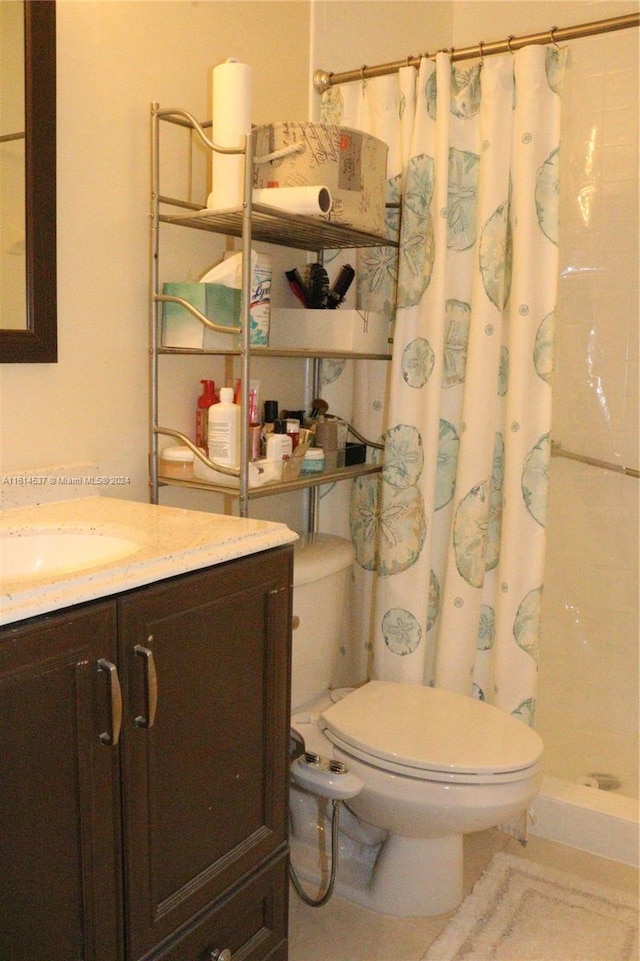 bathroom with toilet, vanity, and curtained shower