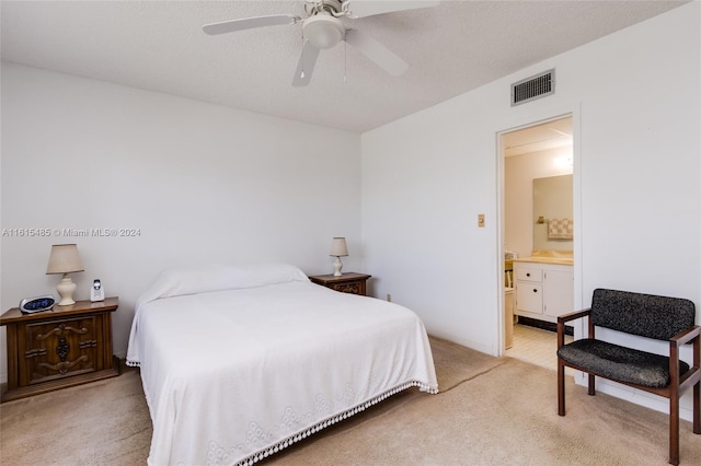 bedroom featuring ensuite bath, ceiling fan, and light carpet