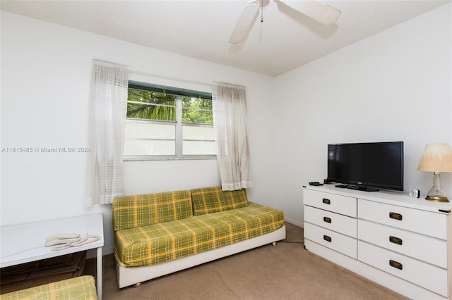 living room featuring light carpet and ceiling fan