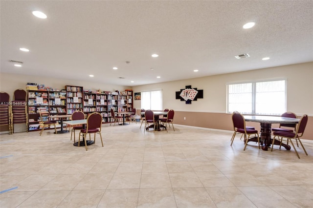 sitting room featuring light tile floors and a textured ceiling