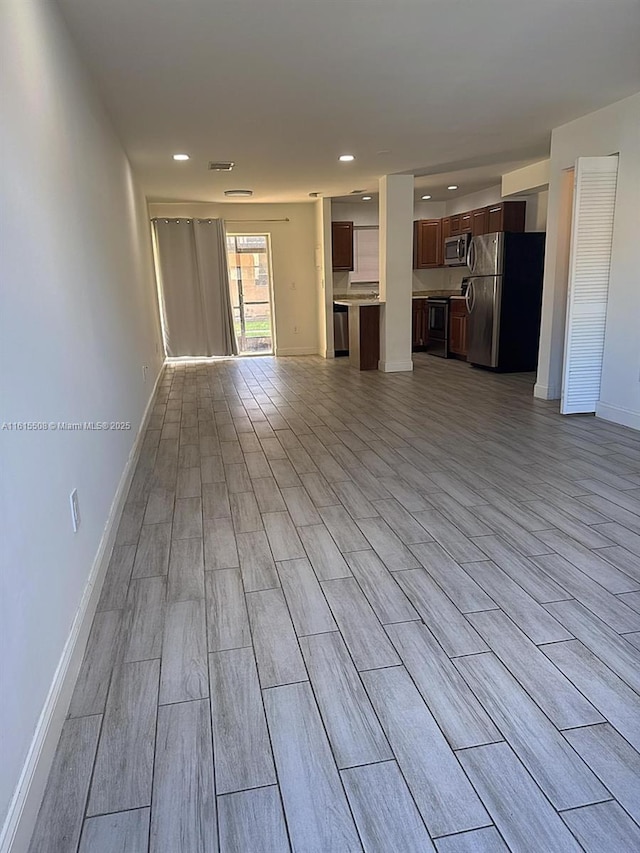 unfurnished living room with light wood-type flooring