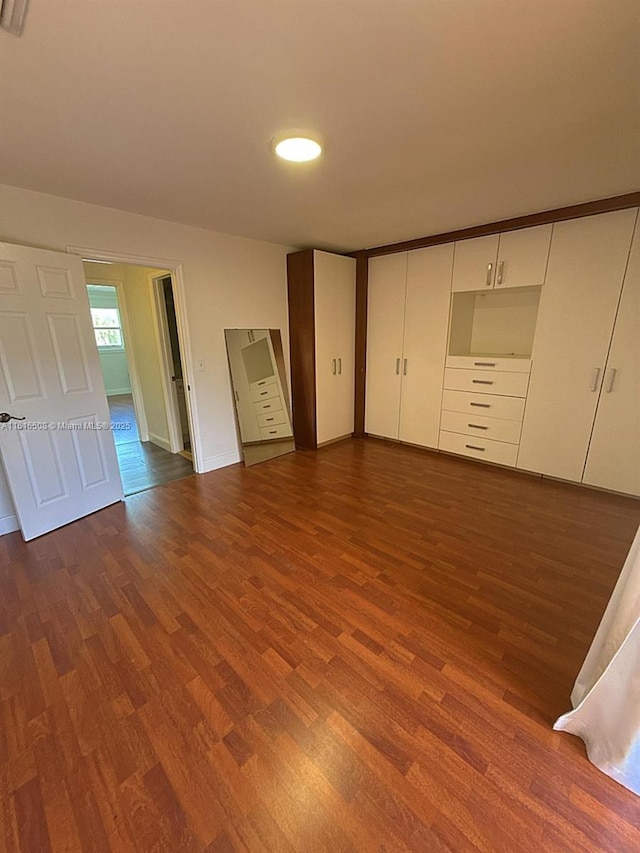 unfurnished bedroom featuring dark hardwood / wood-style floors