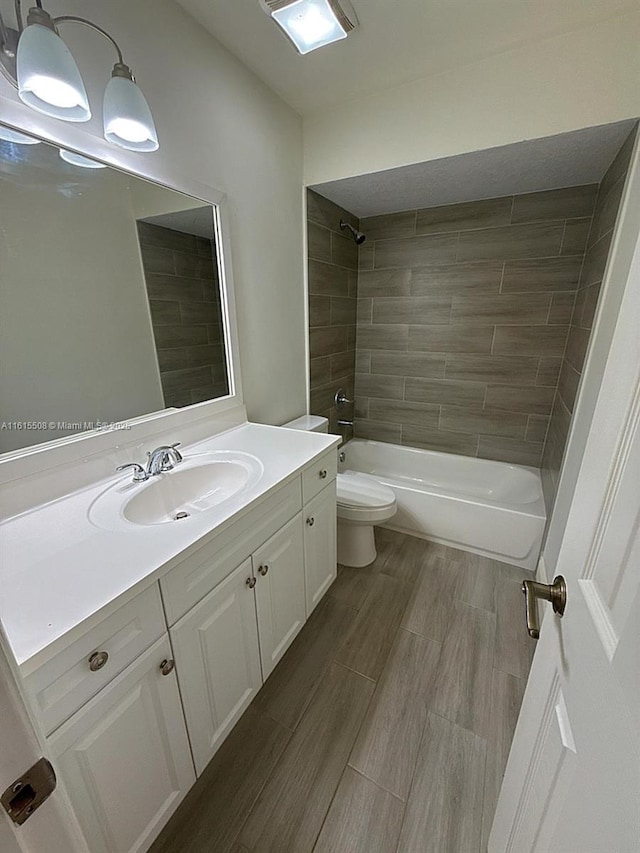 full bathroom with vanity, toilet, and tiled shower / bath combo