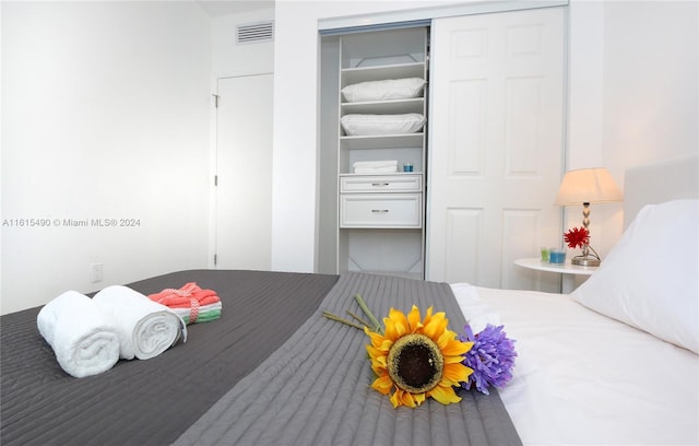 bedroom featuring visible vents and a closet