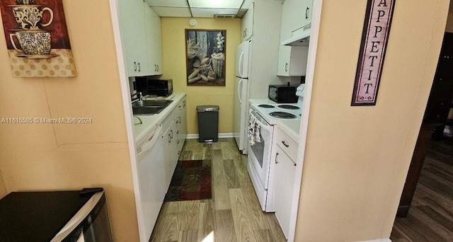 kitchen featuring white cabinets, light hardwood / wood-style floors, and white appliances