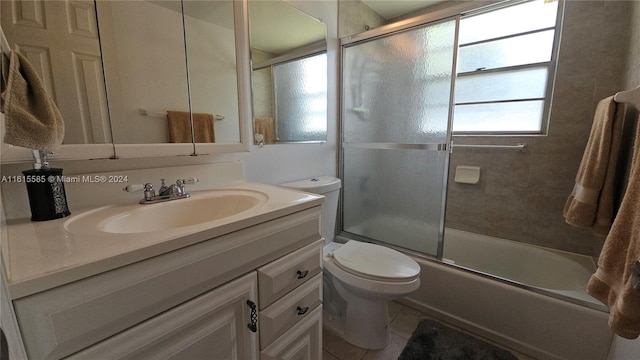 full bathroom with tile patterned floors, vanity, toilet, and shower / bath combination with glass door