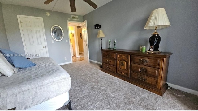 bedroom with ceiling fan and light carpet