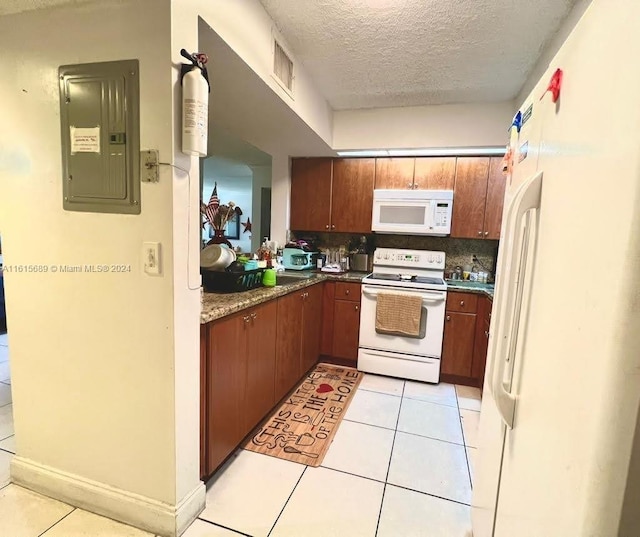 kitchen with light tile patterned floors, white appliances, electric panel, and a textured ceiling