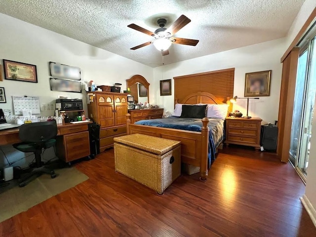 bedroom with ceiling fan, dark wood-type flooring, and a textured ceiling