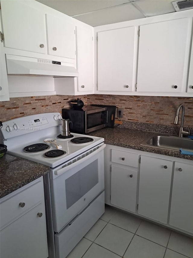 kitchen with sink, tasteful backsplash, light tile patterned floors, electric range, and white cabinets