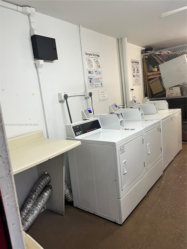 clothes washing area with separate washer and dryer