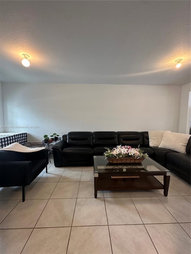 living room with light tile patterned floors and a textured ceiling