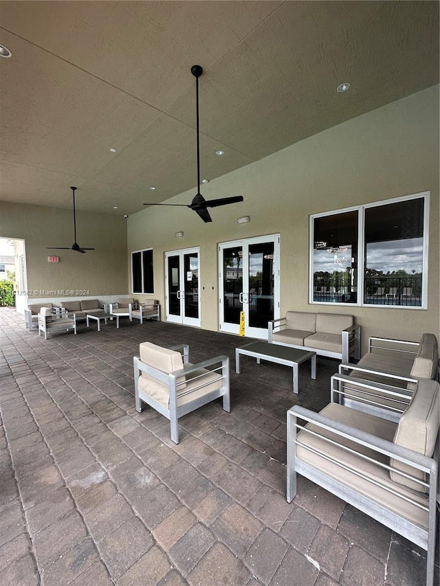 view of patio with an outdoor living space, french doors, and a ceiling fan