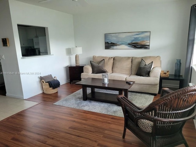 living room with dark hardwood / wood-style floors and ceiling fan