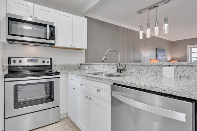 kitchen featuring pendant lighting, stainless steel appliances, light tile patterned floors, white cabinets, and sink