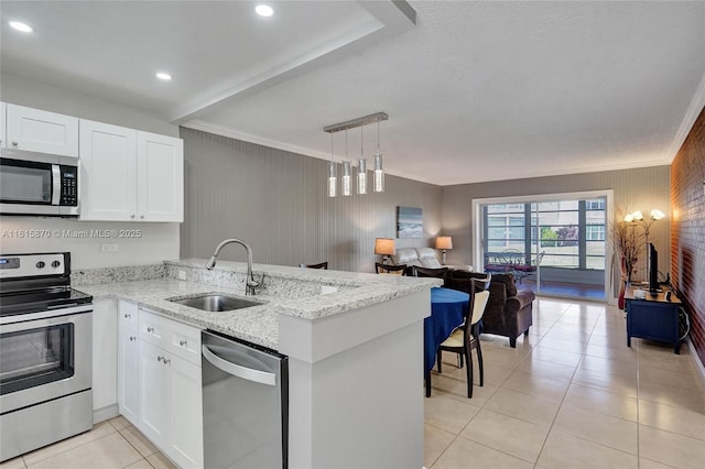 kitchen featuring kitchen peninsula, appliances with stainless steel finishes, and sink