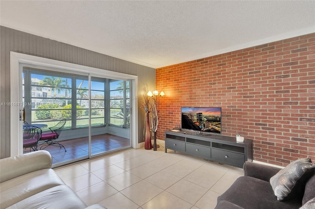 living room with brick wall, a textured ceiling, and light tile patterned floors