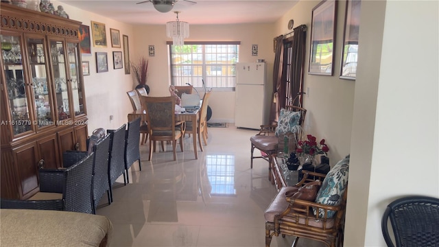 tiled dining space with ceiling fan