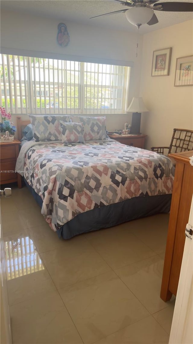 bedroom featuring tile patterned floors and ceiling fan